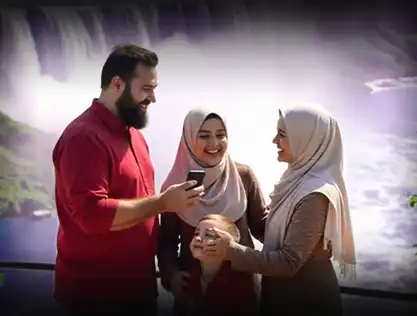A happy Muslim family enjoying time together at a scenic waterfall